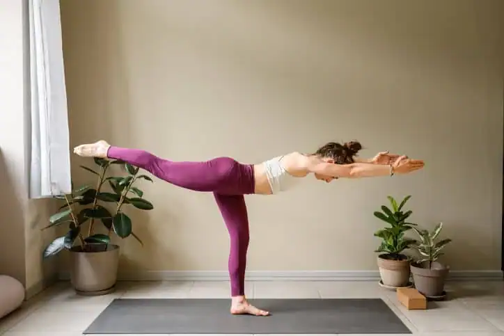 Woman doing Yoga exercise Reigate to help with toning the body. 
