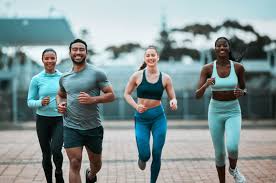 Sculpting Sleek Arms: The Essential Role of Cardio in Toning Without Bulking Up 3 image of people running to incorporate cardio Reigate exercise into their life to help tone arms and body.