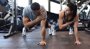 Image of man and woman doing Cardio Reigate to tone their arms. 